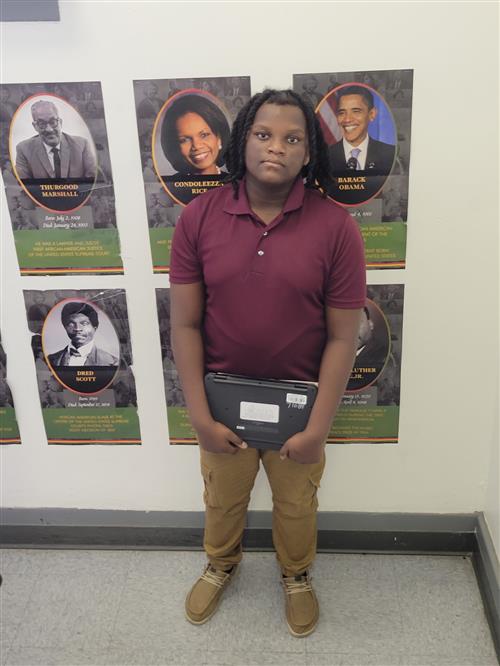 Se'Maj Thomas, Eagle Nest School's Stairclimber for October, poses with his award plaque.